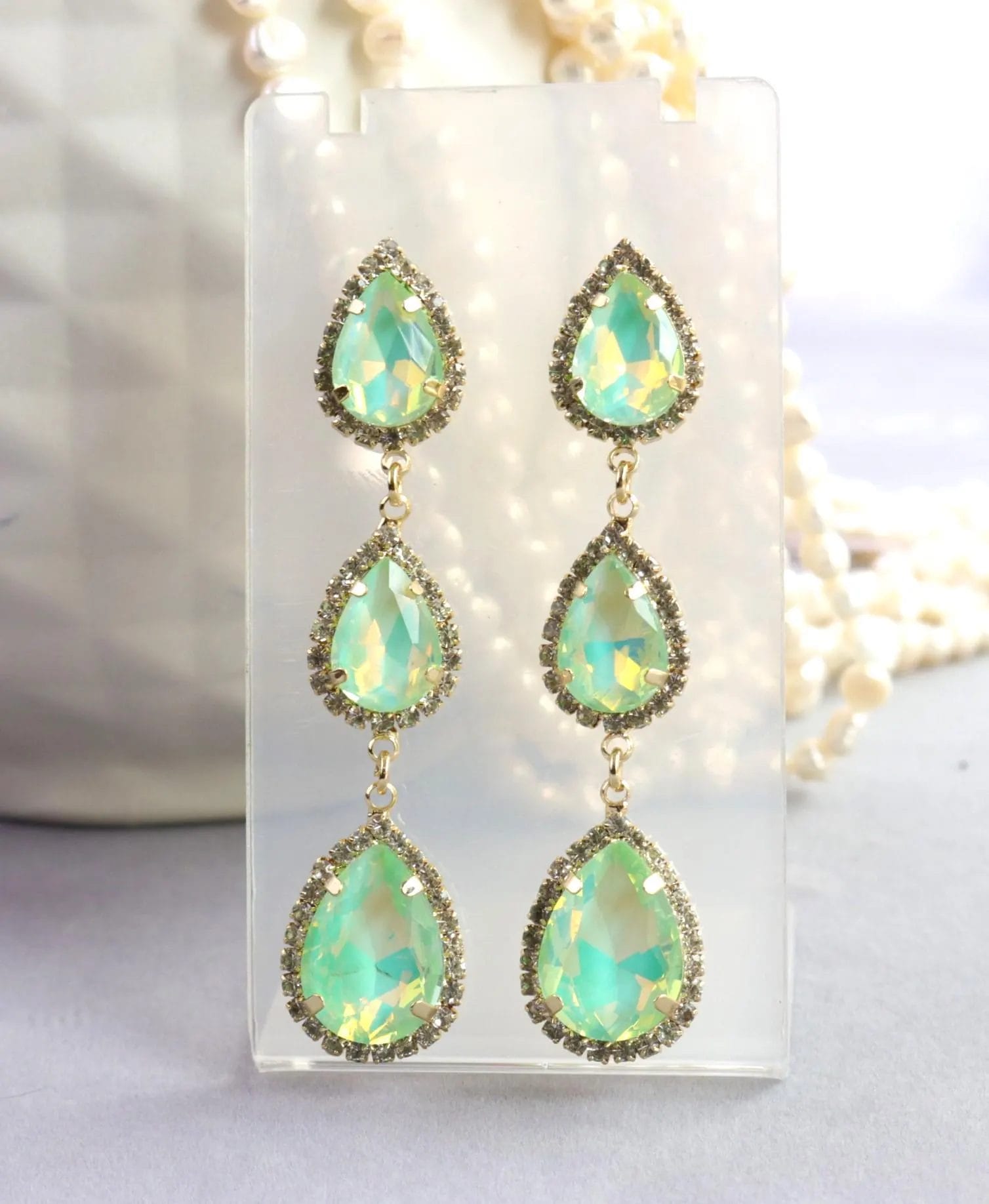 Triple drop mint green opal crystal teardrop earrings with halo rhinestones in gold or silver tone setting with flashes of iridescent yellow