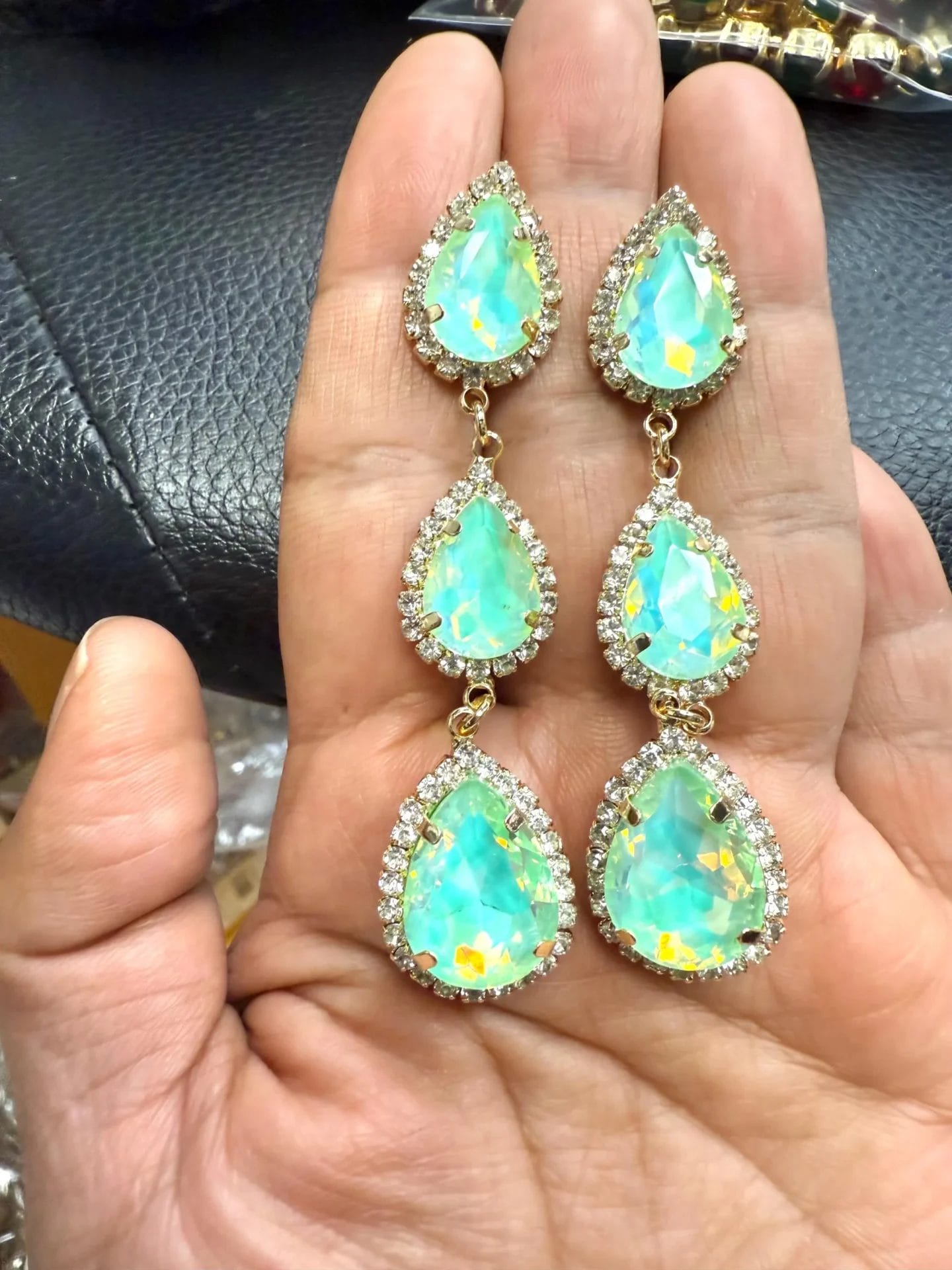 Triple drop mint green opal crystal teardrop earrings with halo rhinestones in gold or silver tone setting with flashes of iridescent yellow