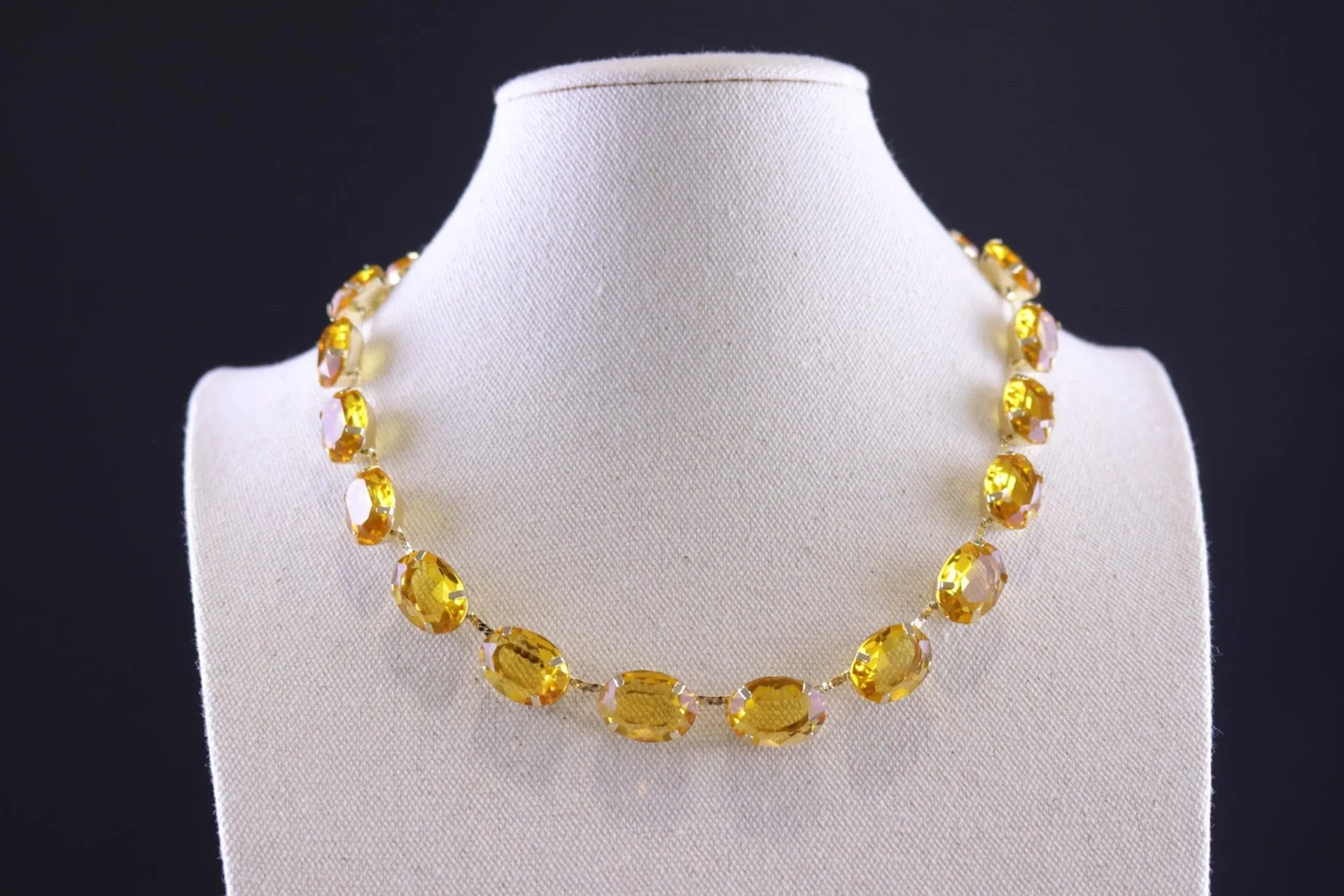 Elegant topaz yellow crystal necklace featuring faceted oval stones in a warm pastel tone