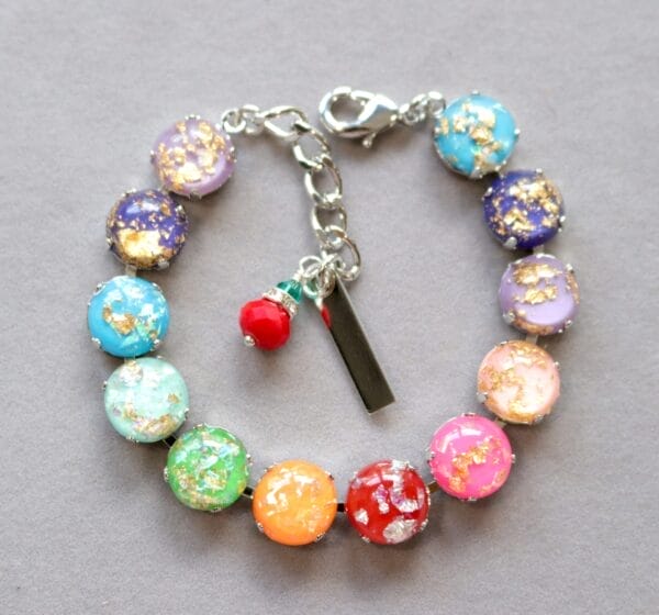Rainbow Fire Bracelet with multi colored cabochons and shimmering gold & silver flecks. LGBTQ Pride jewelry in silver or gold finish.