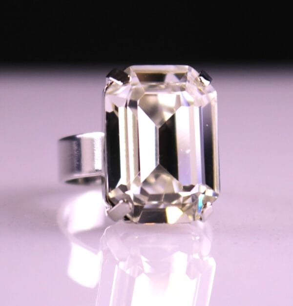 Emerald-cut clear Austrian crystal ring with diamond-like sparkle. Adjustable gold or silver band. Perfect for bridal, wedding, prom, or pageant style.