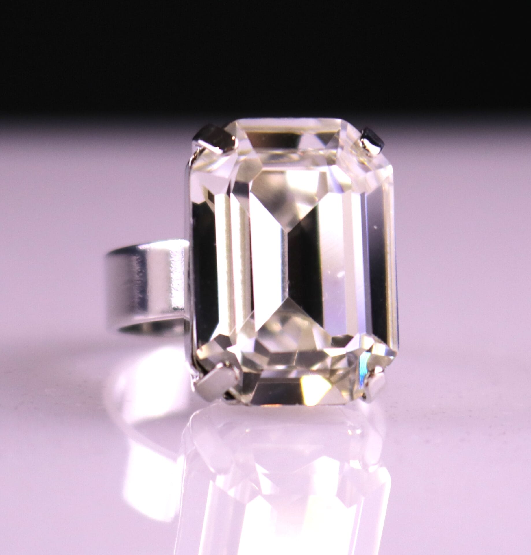 Emerald-cut clear Austrian crystal ring with diamond-like sparkle. Adjustable gold or silver band. Perfect for bridal, wedding, prom, or pageant style.