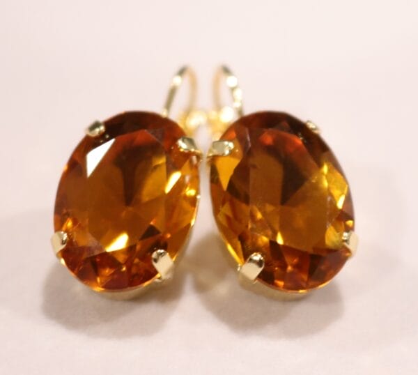 Oval topaz drop earrings in warm golden hue
